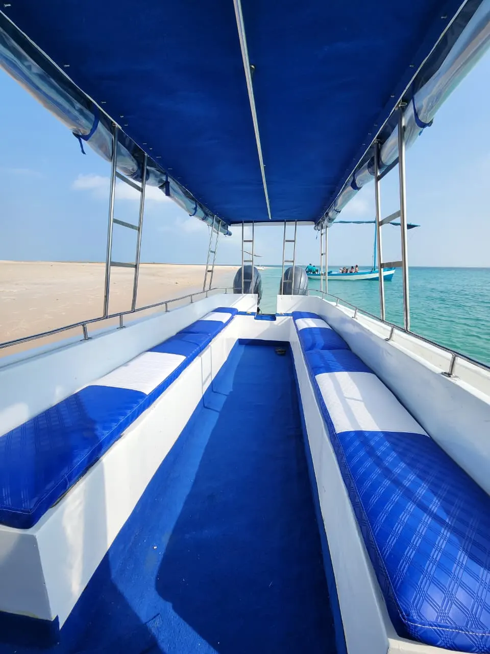 The Bazaruto boat — Inside the boat, with cushioned seating and a canopy